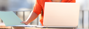 Woman submitting report on laptop