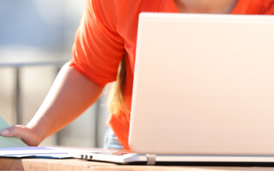 Woman submitting report on laptop