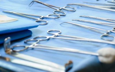 Tray of surgical instruments on blue wrap