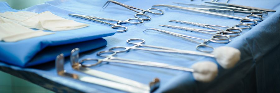 Tray of surgical instruments on blue wrap